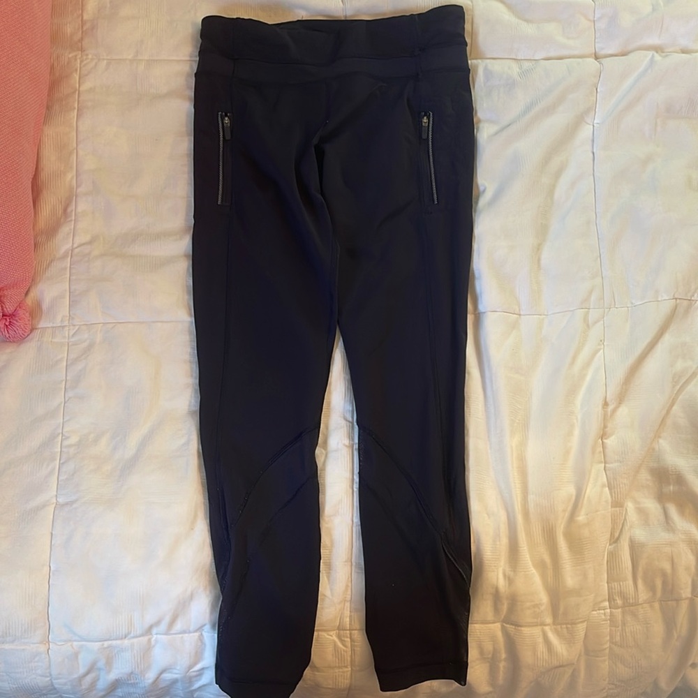 Navy Lululemon leggings with mesh diagonal around calf